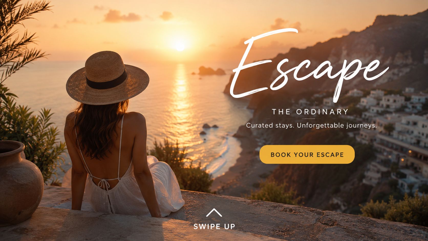 A woman in a sun hat looking out over a coastal Mediterranean village at sunset.